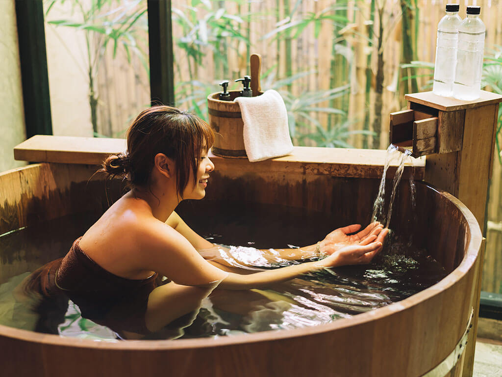 Japanese woman bathing in a open-air hot spring onsen in Nagoya