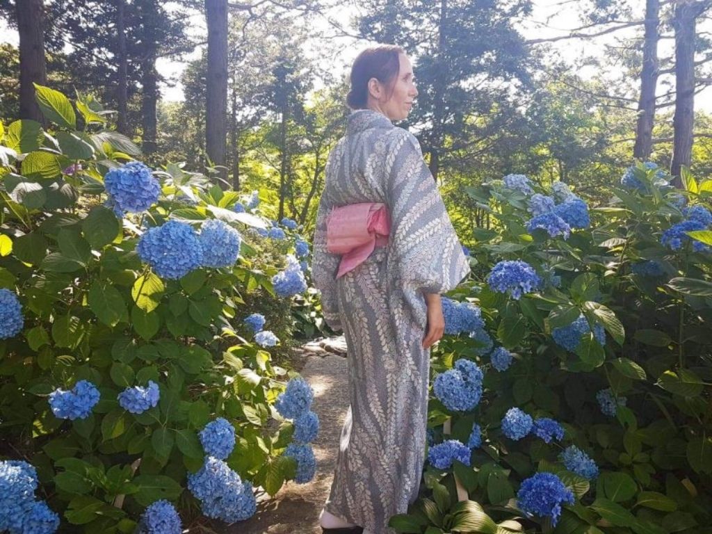 Elly wearing her kimono and walking through flowers. 