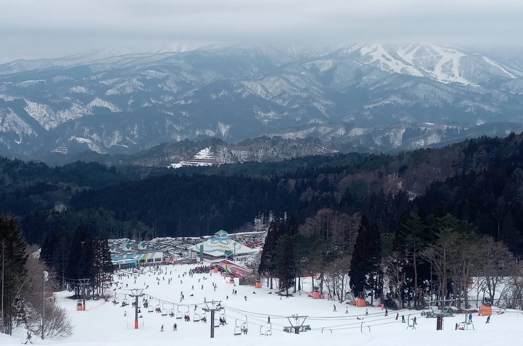 A view from above of Washigatake Ski Resort with vast mountains as far as the eye can see.