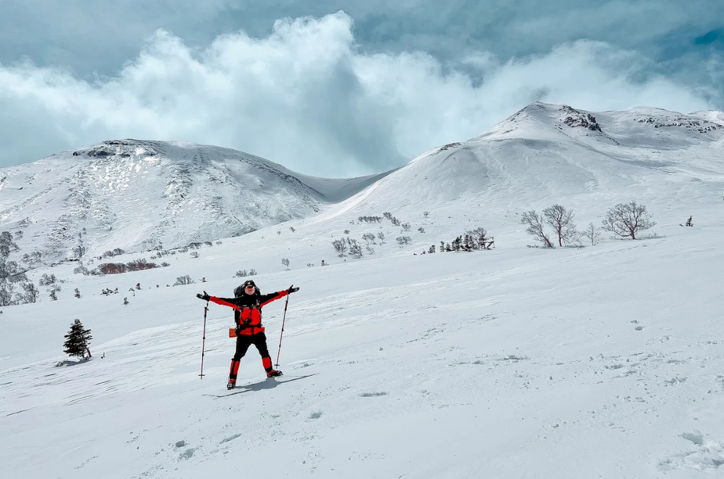 A skiier in a red jacket poses at Mt. Norikura Snow Resort.
