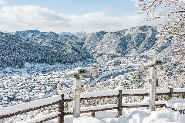 The viewpoint from Gujo Hachiman castle overlooking the snow-covered town and mountains.