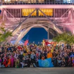 Participants dressed up in Halloween costumes stand for a picture in front of Chubu TV Tower.